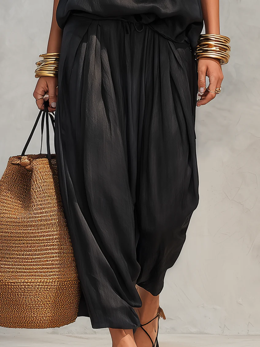 Tuta sarouel in raso nero da donna